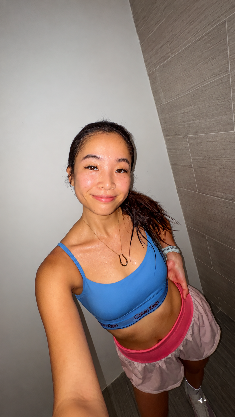 Esther wears the Amara Keepsake Necklace after a 10 km run.